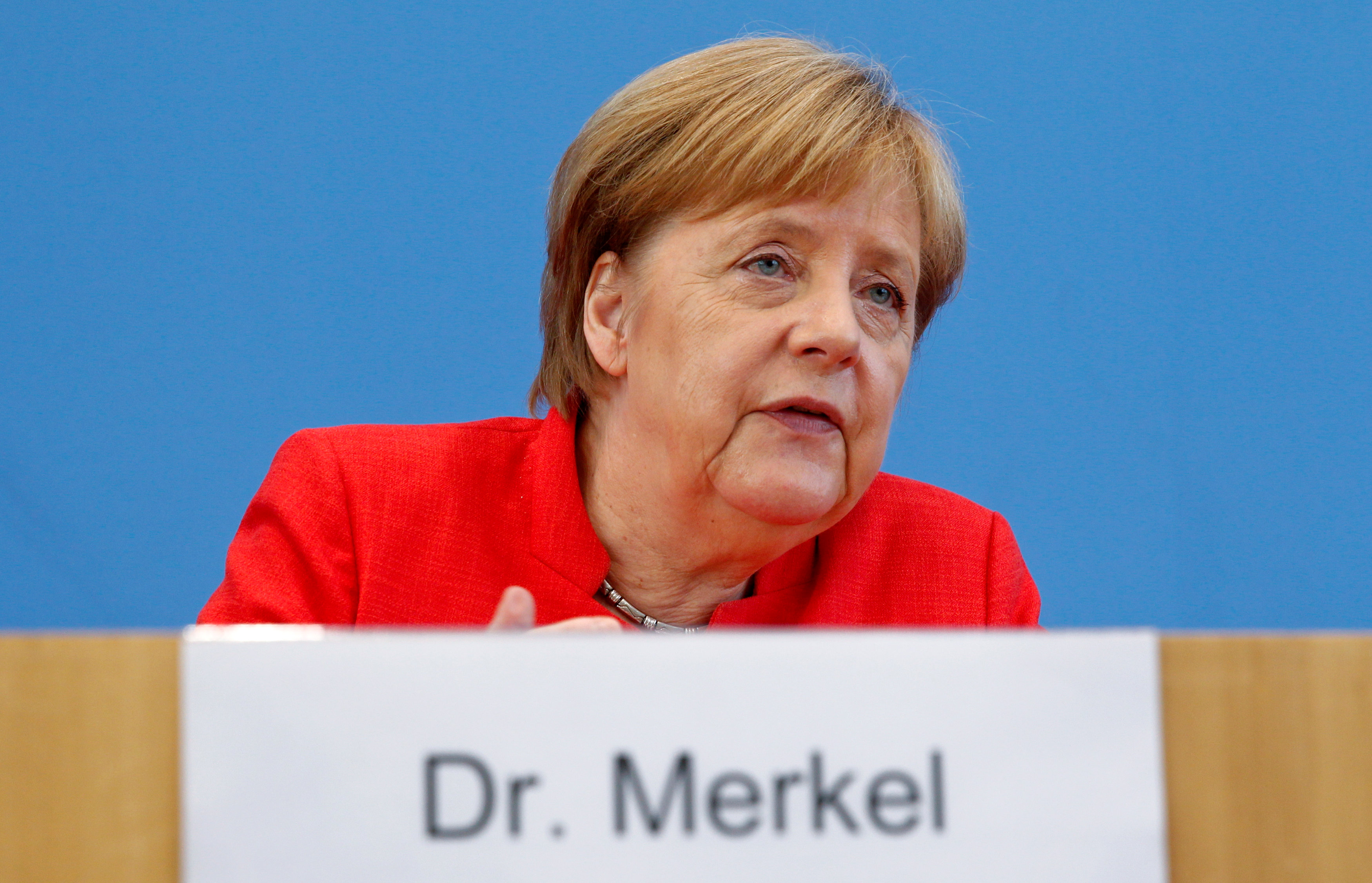 Merkel welcomes end of bailout programme, says its impact will continue