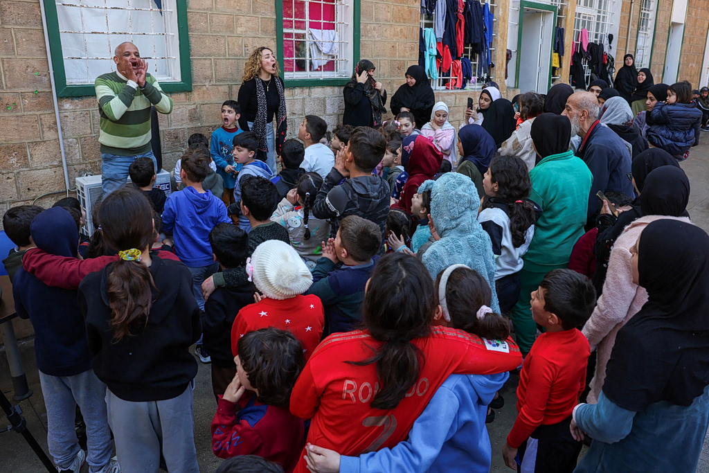 Displaced children are entertained at the yard of the Hariri High School II, now used as a temporary shelter, amid escalating hostilities between Israel and Hezbollah, as the U.S.-Israel conflict with Iran continues, in Beirut, Lebanon, March 27, 2026. REUTERS/Mohamed Azakir